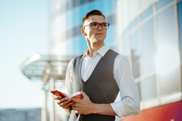 man with a takeaway coffee reading a message on his smartphone .