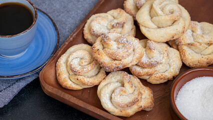 Homemade cottage cheese shortbread cookies shape rose. Dark background. Coffee time.
