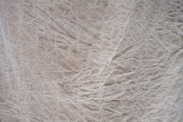 Fototapeta premium distresed crinkled tan cloth covering with folded marks