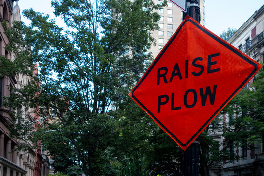 orange and black sign raise plow for the winter months of New York City