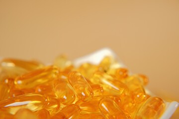 Fish oil capsules in a white ceramic bowl. omega fatty acids. supplements and vitamins. High quality photo