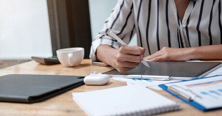 business woman hands holding electronic pen ( stylus pen ) and working on black digital tablet pc...