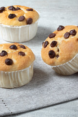 Muffins with chocolate close up on gray table.