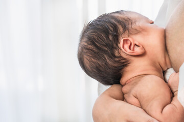 newborn infant baby having milkfeeding from mother breast