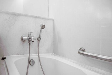 Bath tub in a small bathroom at the apartment