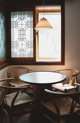 Photo of light coming through wooden chairs and table