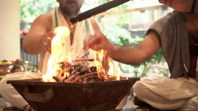 Making fire for rituals pooja  and added some ghee dark theam wide shot