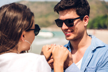 Vacation romantic lovers young happy couple hug and standing on sand at sea having fun and relaxing together on tropical beach.Summer travel
