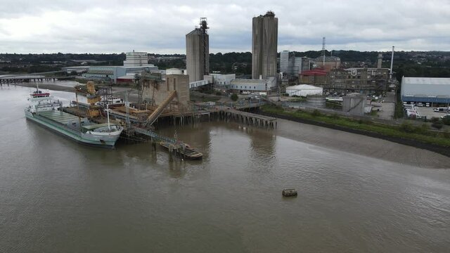 Ship Loading at jetty Hanson Ready-mixed Concrete site Erith Kent UK Aerial footage