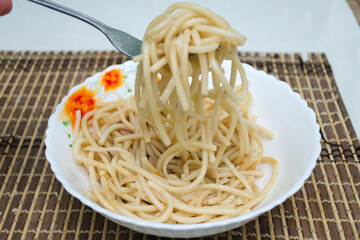 spaghetti in a plate on the kitchen table