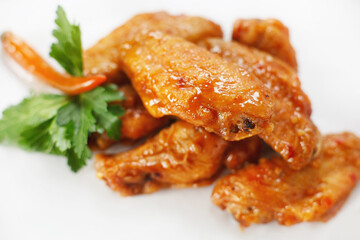 fried chicken teriyake with herbs and sesame seeds on a white background