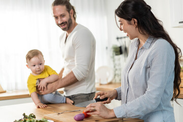 Caucasian family, Mother cook foods with dad and baby son in kitchen.