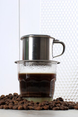 Vietnamese Coffee with Condensed Milk in Glass Cups and Traditional Metal Coffee Maker Phin. Traditional Method of Making of Vietnamese Coffee Drip. Space for Text. Or Advertisement