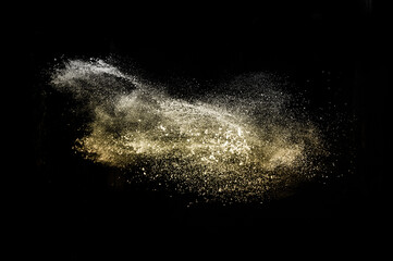 Fototapeta na wymiar golden powder splash in black background