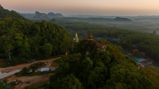Time lapse Aerial view of Khao Na Nai pagoda stupa. Luang Dharma Temple Park with green mountain hills and forest trees, Surat Thani, Thailand. Thai buddhist temple archtecture. Tourist attraction