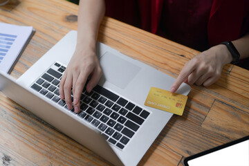 Cropped shot woman payment or banking online with computer laptop.