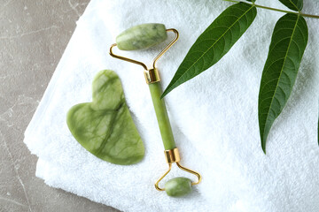 Skin care concept with face roller on gray textured table © Atlas