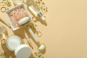 Skin care beauty concept with face roller on beige background