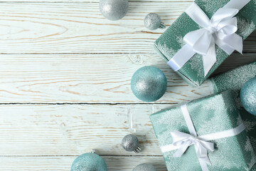 Gift boxes and baubles on white wooden table