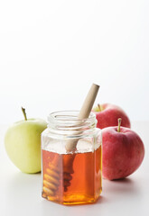 Jewish holiday Rosh Hashana background with honey and apples on white background