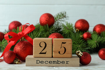 Christmas accessories and cube calendar on wooden table