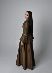 Naklejka premium Full length portrait of beautiful young asian woman with long hair wearing medieval fantasy gown costume. Graceful standing posing walking away, isolated on studio background.