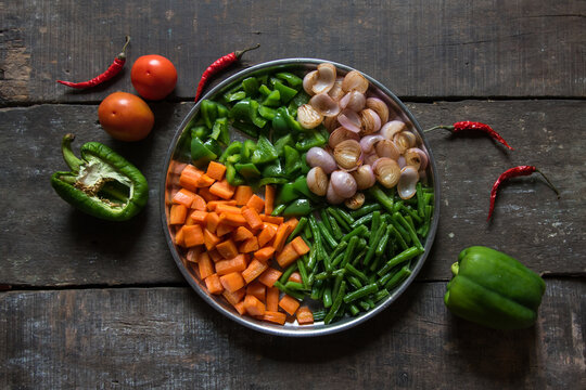 Freshly Chopped Raw Vegetables Carrots, Beans, Onion And Green Capsicum. Ready To Cooking Items. Top View.