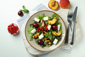 Concept of tasty food with salad with grilled peach on white background