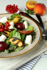 Concept of tasty salad with grilled peach, close up