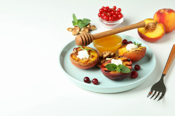 Concept of tasty salad with grilled peach on white background