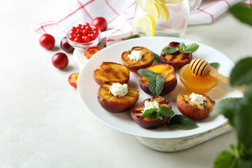 Concept of tasty food with plate with grilled peach