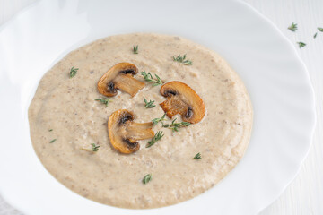 Close-up view of creamy mushroom soup puree made of blended champignons, potatoes and dairy cream...