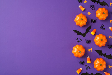 Top view photo of halloween decorations small pumpkins candy corn spiders web cats and bats...