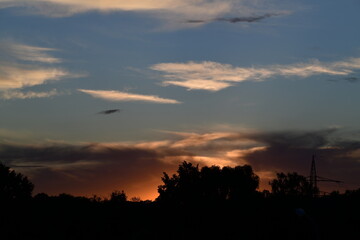 sunset behind forest