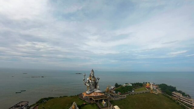 god statue aerial shots with arabian sea in the background at morning