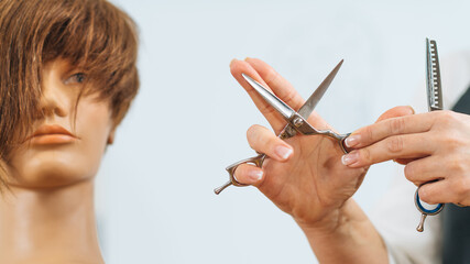 Hand of a Hairdresser Holding Hairdressing Scissors, Explaining Haircutting Techniques to Students