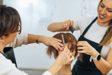 Hairdressers Training with Mannequin Head in Education Center