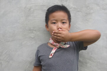 boy covering his mouth - Asian boy covering his mouth with his hand, doesn't like it, doesn't eat, doesn't talk.