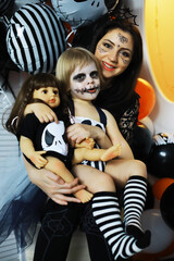 happy family with childrens in costumes and makeup on a celebration of Halloween