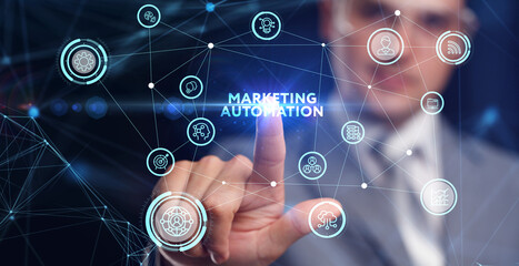 Planning marketing strategy. Business, Technology, Internet and network concept. Young businessman shows the word: Marketing automation