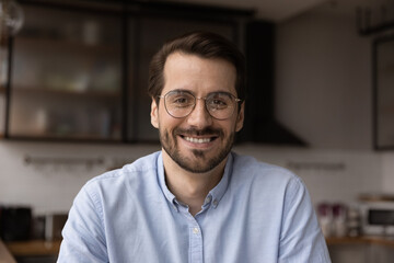 Head shot profile picture 30s businessman sit in kitchen webcam view, conduct business negotiation from home use video call app due covid. Talk to client of friend remotely via videoconference concept