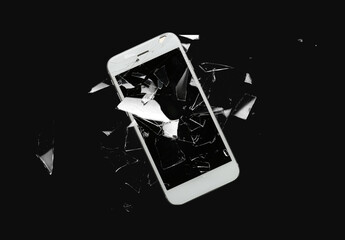 Mobile phone with cracked glass screen on dark background