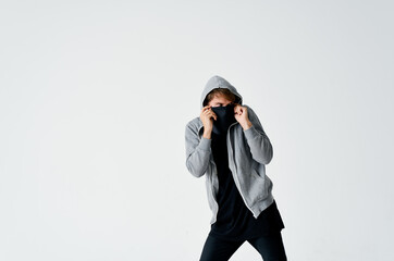 a man in Balaklava with a hood on his head sneaks stealing hooligan crime