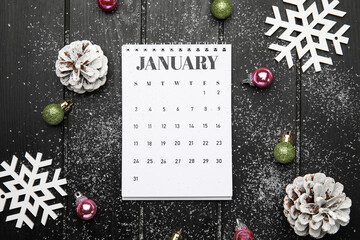 Christmas composition with calendar on dark wooden background