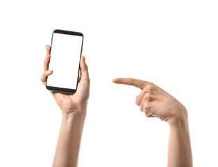 Woman pointing at mobile phone on white background