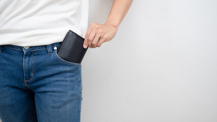 Close up man hand pick up wallet out of jean pocket white background copy space crop shot