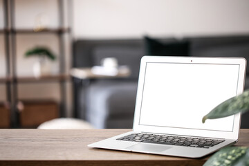 Modern laptop on table in room