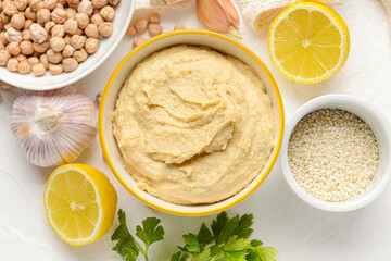 Composition with tasty hummus on light background