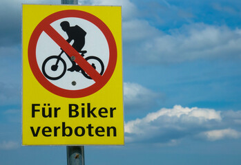 Forbidden for cyclists. Roadsign in Germany.
Cycling prohibited sign post against cloudy sky. Place for text.