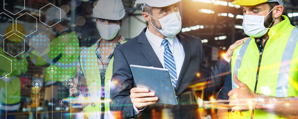 Diversity factory worker working with tablet, Industrial Engineer in the hard hat uses  small...